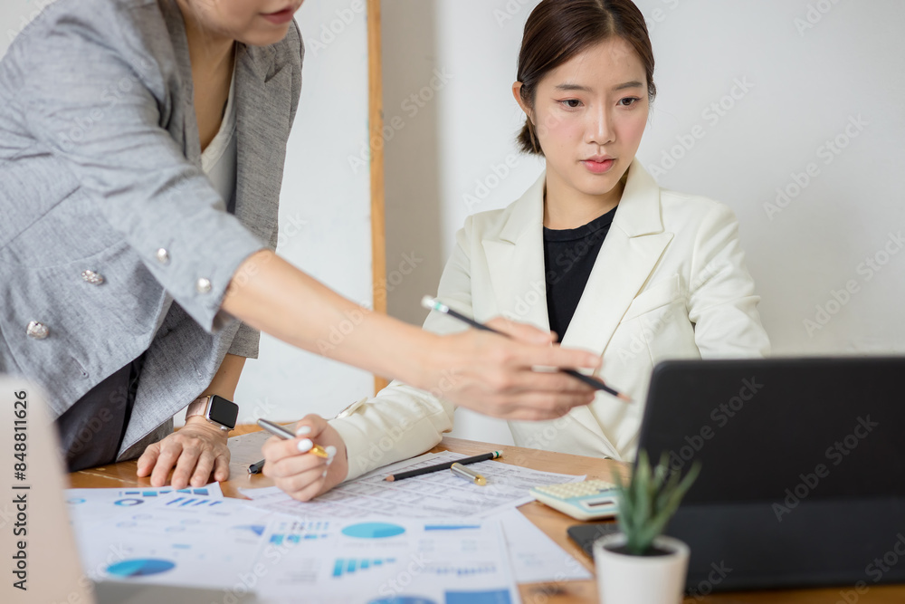 Fototapeta premium Two businesswoman meeting and data analysis and statistics report for budget an office