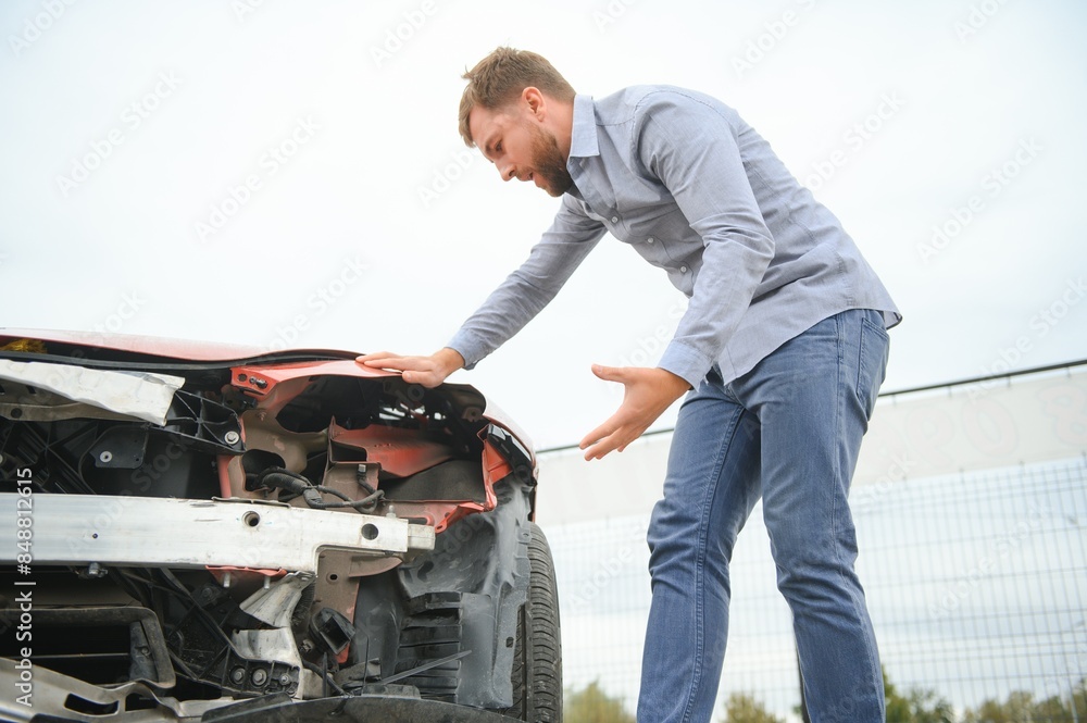 Car accident. Man after car accident. Man regrets damage caused during car wreck Car accident. Man after car accident. Man regrets damage caused during car wreck