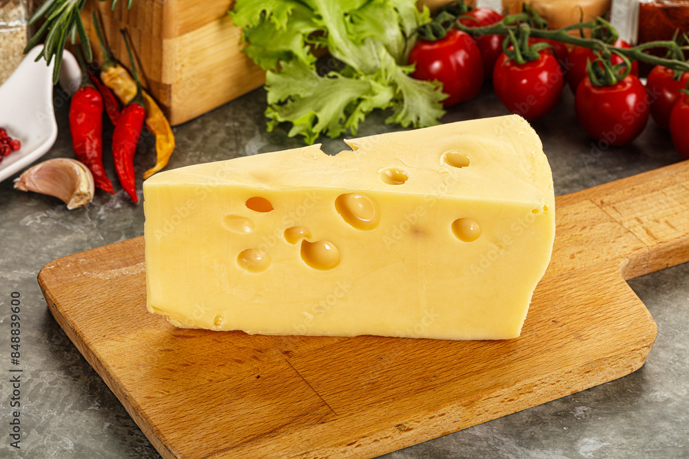 Swiss Maasdam cheese triangle over board Swiss Maasdam cheese triangle over board