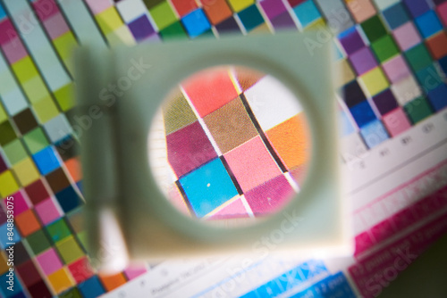 A close up detail magnifying glass showing the dot matrix printing technique using half tone and cmyk print inks. Large format printing for advertising and cardboard box graphics and logos.