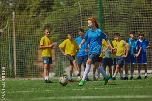 Athletic Training for Kids. Diverse group of children wear soccer uniforms and training on outdoor field. Concept of sport, school, childhood, hobby, active lifestyle