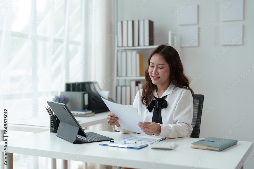 Asian businesswoman, attractive stylish woman working on financial and accounting documents. Laptop on the table in the office startup business idea. Asian businesswoman, attractive stylish woman working on financial and accounting documents. Laptop on the table in the office startup business idea.