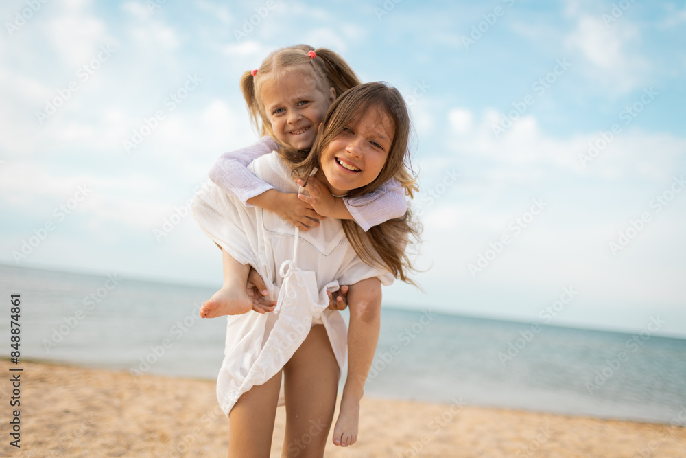 Sister's children relax, play and have fun on the sandy seashore