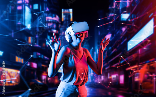 Female standing in virtual reality cyberpunk style building in meta wearing VR headset connecting metaverse, future cyberspace community technology, She enjoy dancing raising two arms. Hallucination.