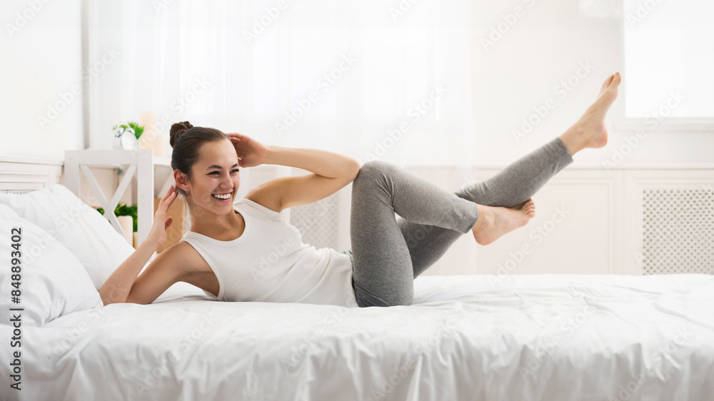 Morning Workout. Woman Doing Abs Exercise On Bed After Wake Up, Panorama Morning Workout. Woman Doing Abs Exercise On Bed After Wake Up, Panorama