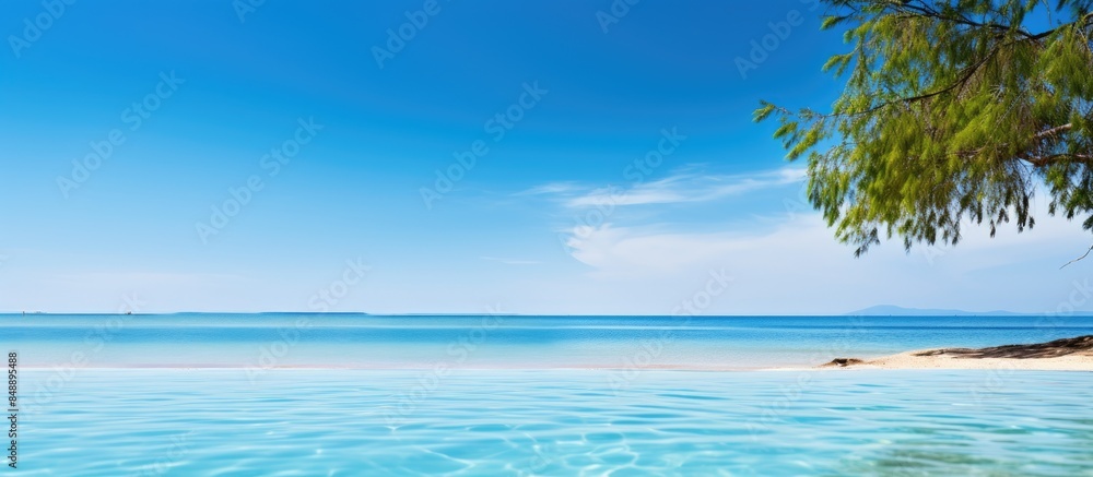 Fototapeta premium A serene beach and pool setting with a clear blue water background ideal for use as a copy space image