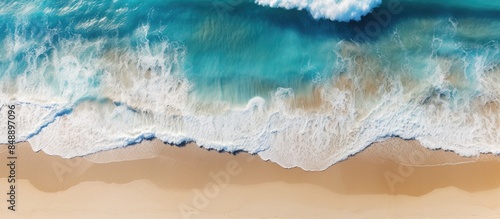 A stunning aerial view of a beach and waves with turquoise water creating a serene summer seascape captured by a drone ideal for a travel concept with copy space image © Ilgun