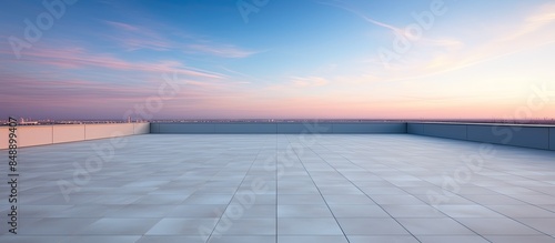 Modern building rooftop on an empty floor set against a picturesque evening sky offers a stunning copy space image