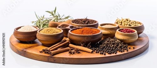 Fototapeta Naklejka Na Ścianę i Meble -  Close up shot of a variety of eastern spices and seasonings displayed in wooden tableware on a white background with copy space image