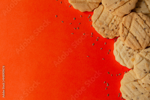 Assorted delicious carrom seed cookies or salted ajwain cookies on an orange background. Top view. photo