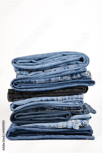 Konstfotografi A beautiful stack of folded denim jeans in different shades of blue and black