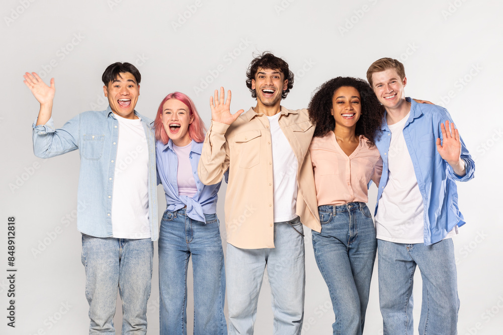 A group of five young adults, representing diverse ethnicities and genders, stand together against a white background. They are all smiling and appear to be happy and friendly. A group of five young adults, representing diverse ethnicities and genders, stand together against a white background. They are all smiling and appear to be happy and friendly.