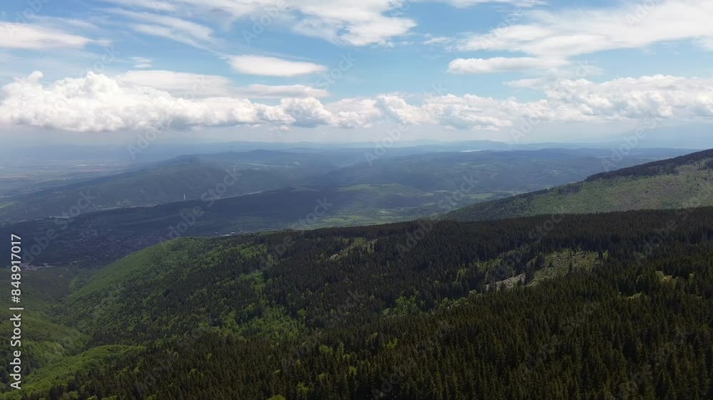 Aerial shot from high up in a mountain. Drone flying across Vitosha mountain, villages can be seen in the distance ,towards the end, clouds casting shade on the land below Aerial shot from high up in a mountain. Drone flying across Vitosha mountain, villages can be seen in the distance ,towards the end, clouds casting shade on the land below