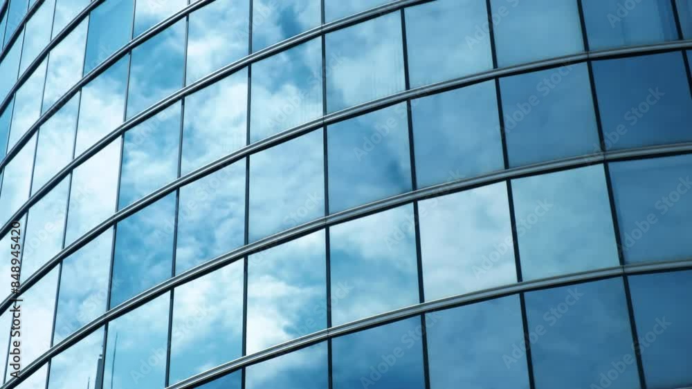 Abstract modern business architecture. Walls made of glass and steel with reflections of buildings and blue sky. Abstract modern business architecture. Walls made of glass and steel with reflections of buildings and blue sky.