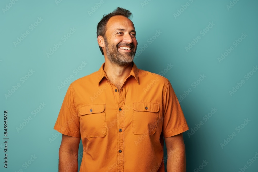 Portrait of a satisfied man in his 40s sporting a breathable hiking shirt isolated in solid color backdrop Portrait of a satisfied man in his 40s sporting a breathable hiking shirt isolated in solid color backdrop