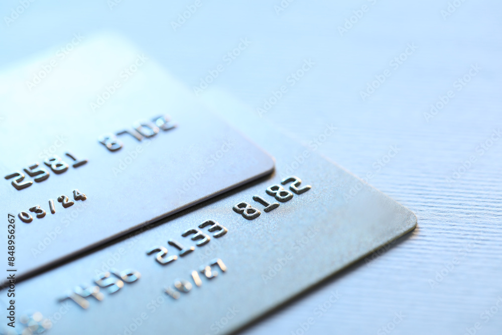 Two credit cards on light background, closeup Two credit cards on light background, closeup
