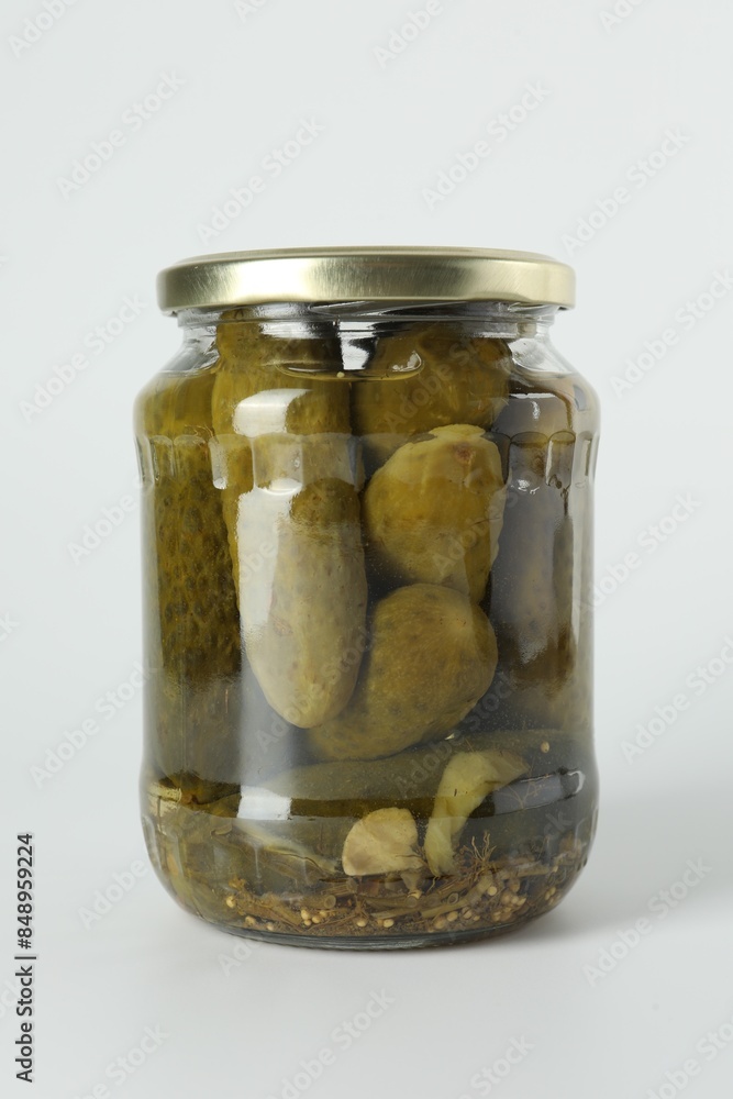 Pickled cucumbers in jar on light background Pickled cucumbers in jar on light background