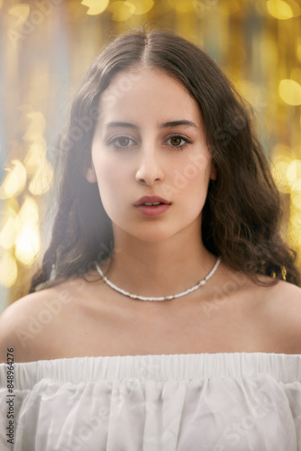 Skin care. Portrait of a woman with beauty face and healthy skin. Beautiful girl model with natural make-up on golden background. On yellow background. Close-up looking into the camera. 