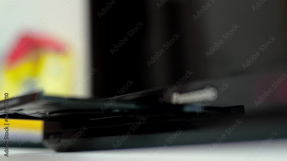 Man puts cd disc to a video player tray. Physical media concept. Man puts cd disc to a video player tray. Physical media concept.