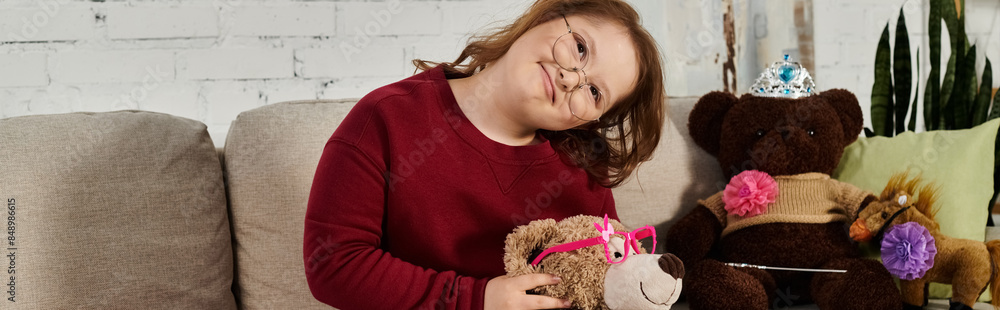 little girl with Down syndrome at home, with her favorite stuffed animals. little girl with Down syndrome at home, with her favorite stuffed animals.