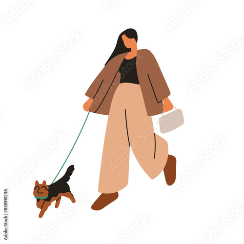 Woman walking dog. Cute puppy on leash and pet owner strolling on street. Fem...