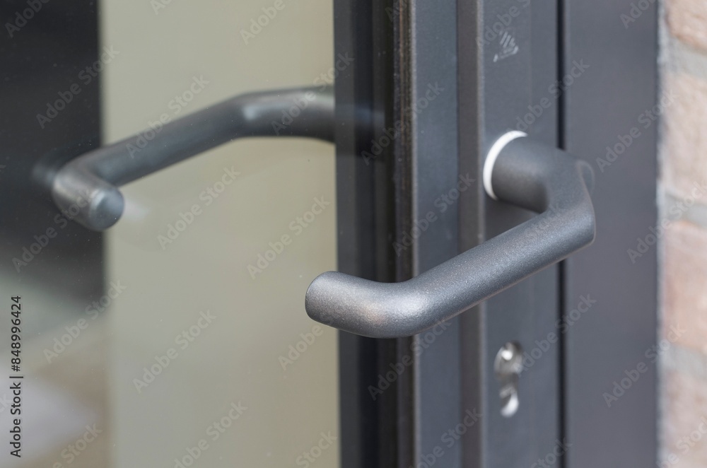 Doorhandle of aluminium glass door.Modern Dutch architecture. Netherlands. Doorhandle of aluminium glass door.Modern Dutch architecture. Netherlands.