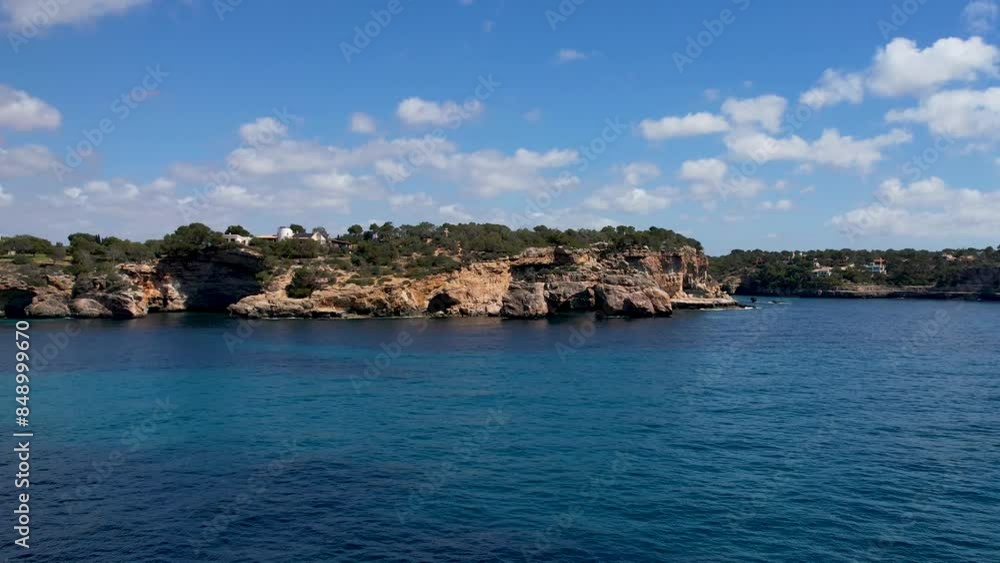 4K Aerial Drone video of a unique rock formation with an arch separated from the cliffs with turquoise clear blue water and beach nearby. Es Pontas, Mallorca 4K Aerial Drone video of a unique rock formation with an arch separated from the cliffs with turquoise clear blue water and beach nearby. Es Pontas, Mallorca