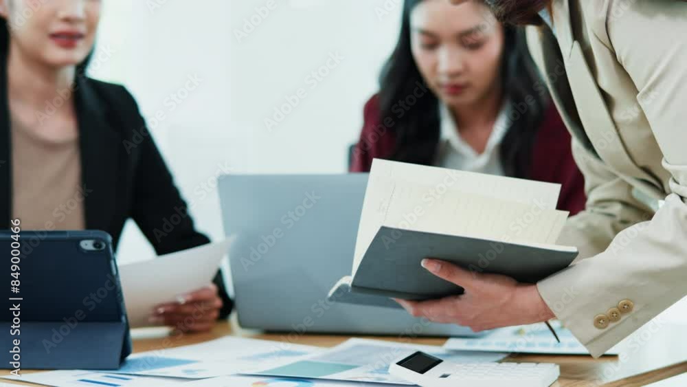 Close up of group hands teamwork businesswoman are meeting working calculate and brainstorming about business financial and marketing on paperwork and presentation. Close up of group hands teamwork businesswoman are meeting working calculate and brainstorming about business financial and marketing on paperwork and presentation.