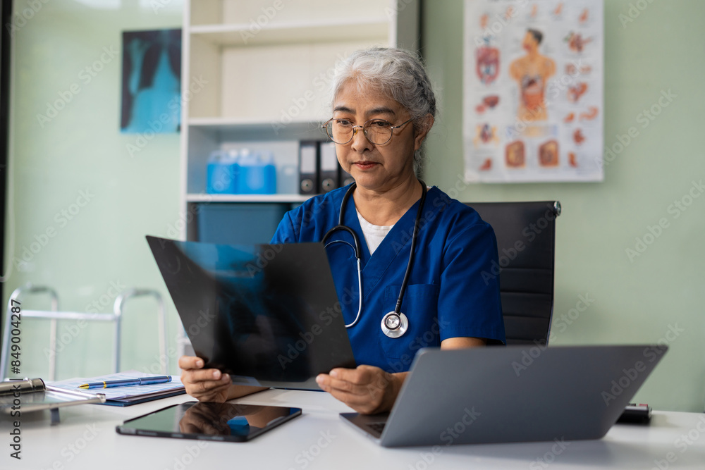 Medical working on digital tablet healthcare doctor technology tablet using x-ray film analyzed the results of medical reports. Medical working on digital tablet healthcare doctor technology tablet using x-ray film analyzed the results of medical reports.