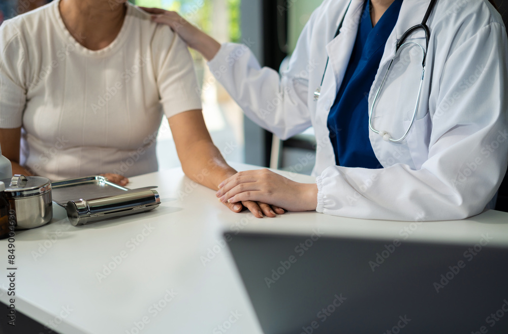 Friendly female doctor hands holding patient hand sitting at the desk for encouragement, empathy, cheering and support while medical examination. Friendly female doctor hands holding patient hand sitting at the desk for encouragement, empathy, cheering and support while medical examination.