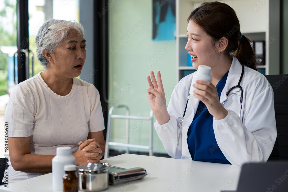 Obraz premium Female doctor consulting senior old patient filling form at consultation, talking to senior old patient filling signing medical paper at appointment visit in clinic..