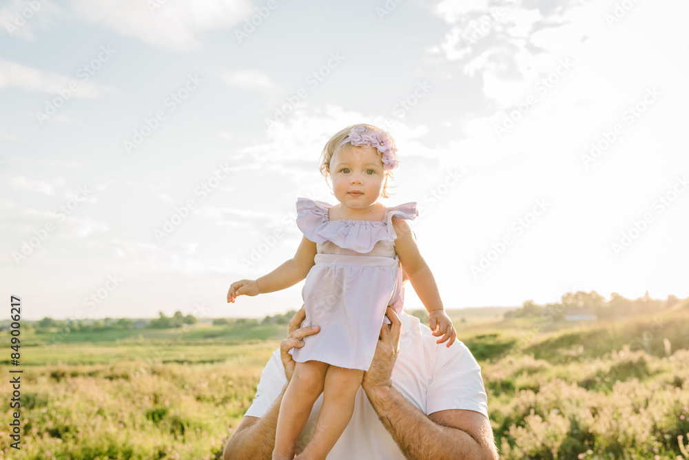 Dad holding child and walk in spring mountains. Kid funny with parent in green grass in field at sunset. Father holds daughter and plays in nature on summer day. Family spending time together. Dad holding child and walk in spring mountains. Kid funny with parent in green grass in field at sunset. Father holds daughter and plays in nature on summer day. Family spending time together.