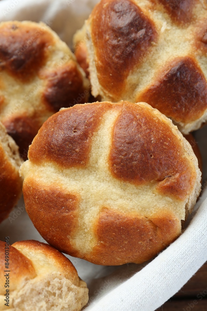 Hot cross buns in basket on table, closeup Hot cross buns in basket on table, closeup