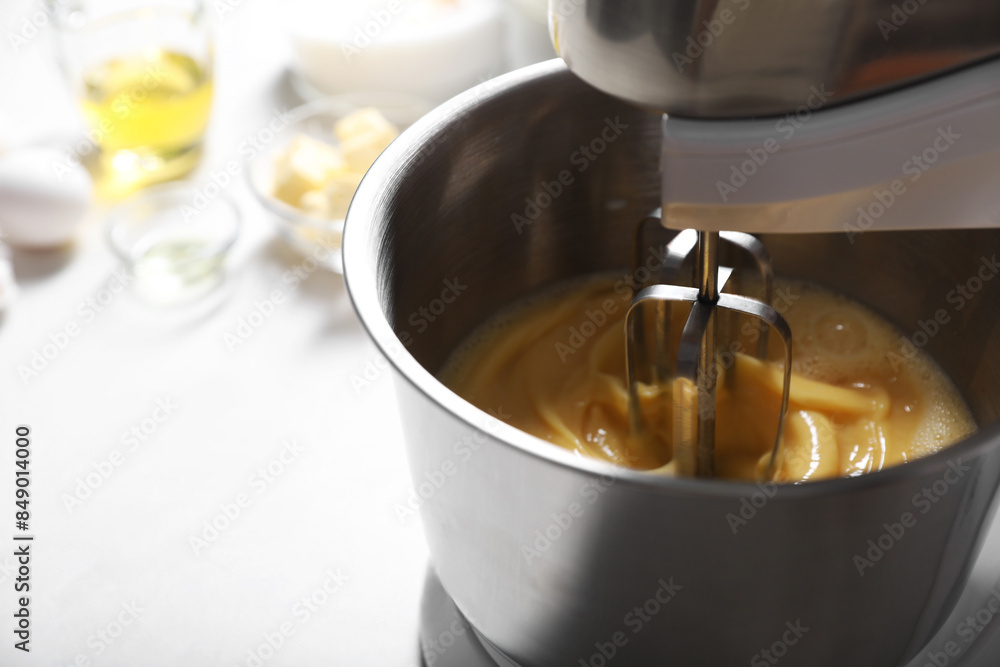 Making dough in bowl of stand mixer on white table. Space for text Making dough in bowl of stand mixer on white table. Space for text