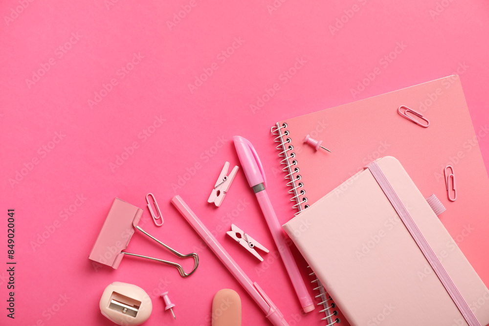 Flat lay composition with notebooks and different stationery on pink background, space for text Flat lay composition with notebooks and different stationery on pink background, space for text