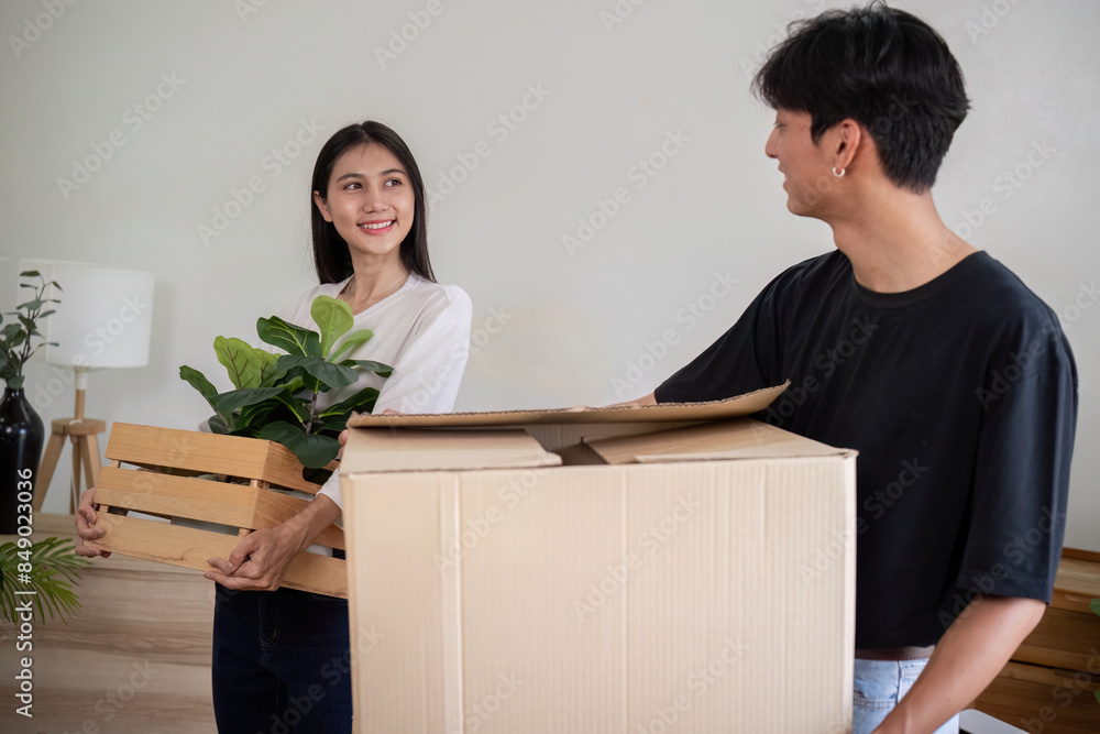 Young Couple Moving into New House, Carrying Boxes and Plants, Starting Fresh in Their New Home, Excited and Happy, Unpacking and Decorating, Beginning a New Chapter Together, Modern Living Space Young Couple Moving into New House, Carrying Boxes and Plants, Starting Fresh in Their New Home, Excited and Happy, Unpacking and Decorating, Beginning a New Chapter Together, Modern Living Space
