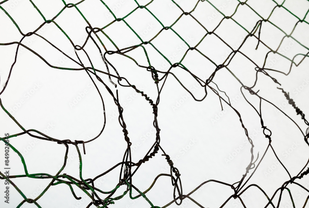 Broken metal mesh fence