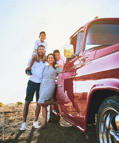 Parents, children and smile with car for road trip, adventure and explore on holiday, weekend or vacation. Travel, vintage pickup truck and mother, father and kids for journey and bonding together © peopleimages.com
