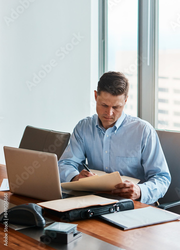 Office, reading and businessman with document, contract and understanding information of case rules. Corporate firm, male lawyer and paperwork of compliance, regulations and approval before signature © peopleimages.com