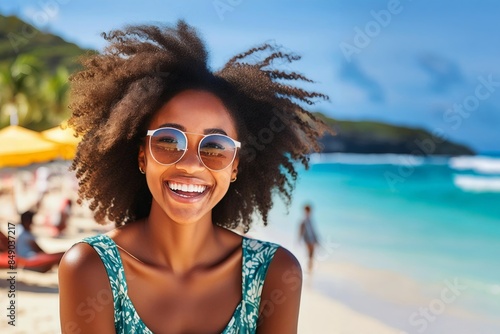 Portrait of an African American girl wearing glasses having fun on a beach. © Fotema