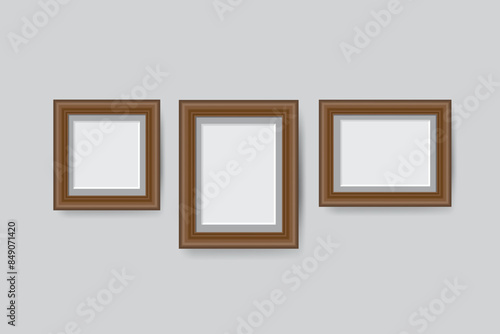 wooden blank picture photo frames stand on a clear wall from the front