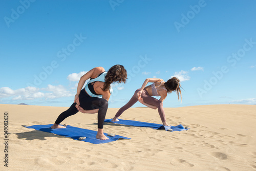 Woman doing yoga and meditation exercises on the beach sand