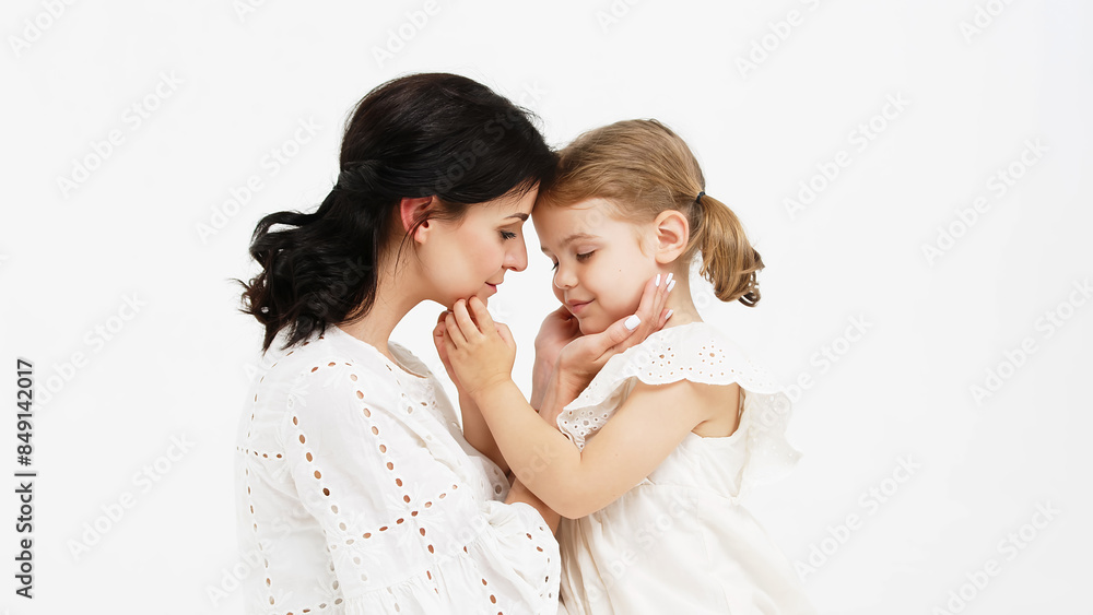 Sensual mother with her little daughter on a light studio background. Family relationship between mother and daughter. Tender moment, family support. Sensual mother with her little daughter on a light studio background. Family relationship between mother and daughter. Tender moment, family support.