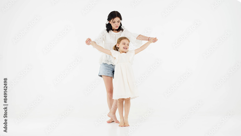 Mother's day, love, family, parenthood, childhood concept. A mother woman in light clothes has fun with a cute little girl. Mother and little daughter isolated on white background. Mother's day, love, family, parenthood, childhood concept. A mother woman in light clothes has fun with a cute little girl. Mother and little daughter isolated on white background.