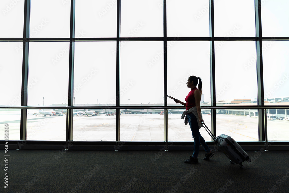 Female passenger waiting her flight at airport Female passenger waiting her flight at airport