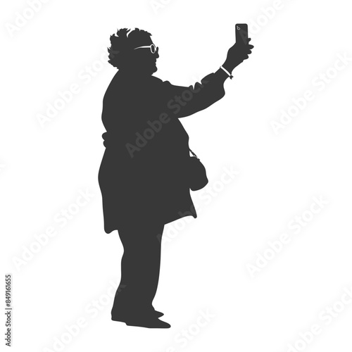 Silhouette of an elderly woman taking a selfie with her smartphone.