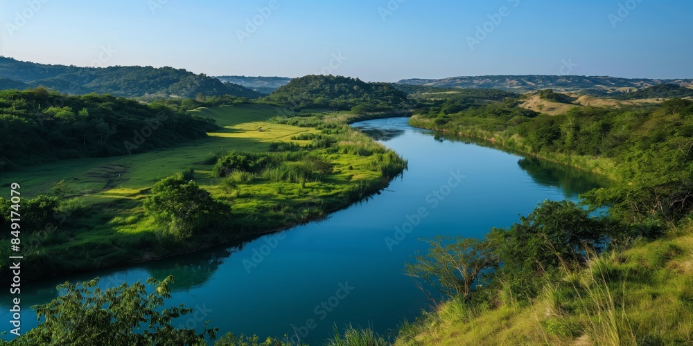 A breathtaking landscape capturing a meandering river amidst vibrant green hills under a clear sky A breathtaking landscape capturing a meandering river amidst vibrant green hills under a clear sky
