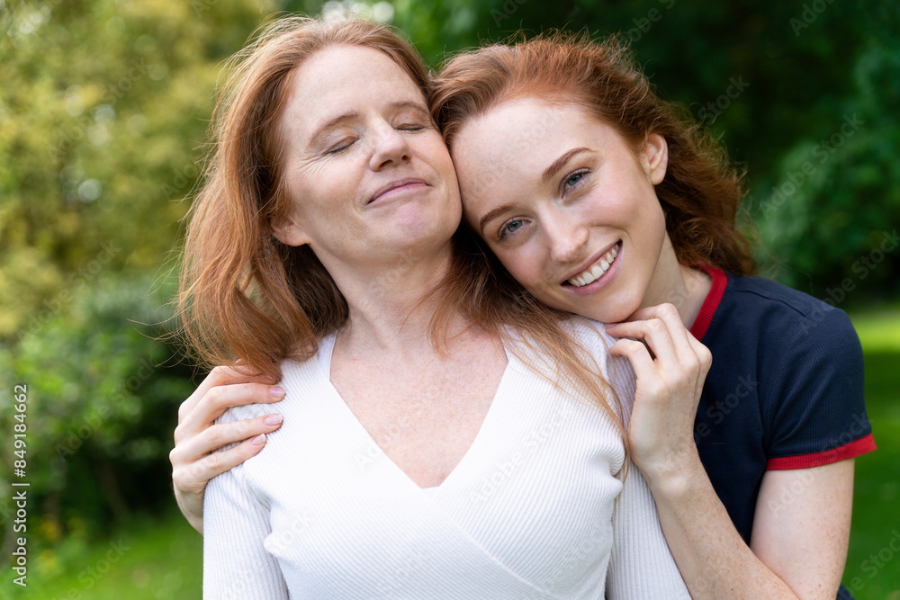 Happy Mother and Daughter Posing Together Outdoors on Sunny Day Happy Mother and Daughter Posing Together Outdoors on Sunny Day