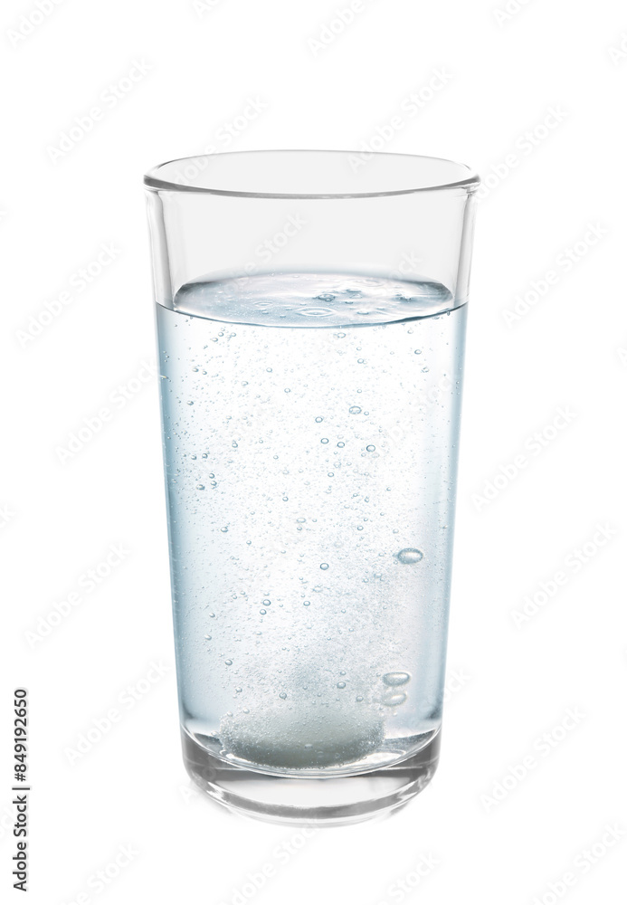 Effervescent pill dissolving in glass of water isolated on white Effervescent pill dissolving in glass of water isolated on white