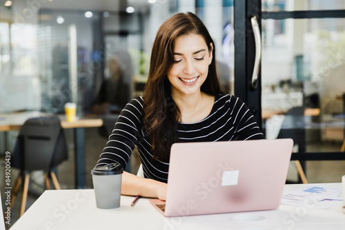 Free Download Young Happy Businesswoman Using Computer in Modern Office - GFXLoad